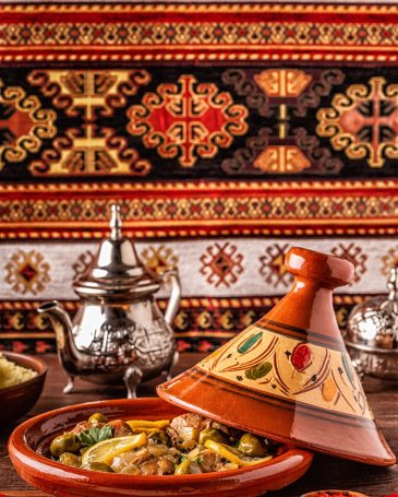 Traditional Moroccan chicken tagine with olives and salted lemons, selective focus.