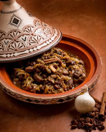 tajine with meat, onion, dried grape and cinnamon